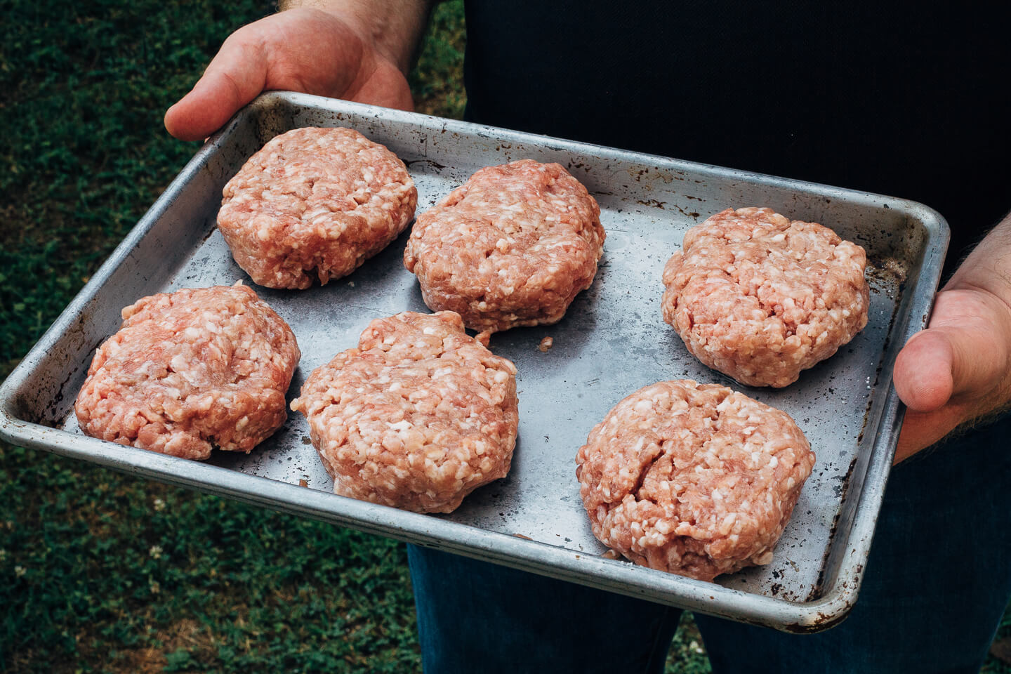 Juicy pork burgers perfectly grilled and topped with velvety melted Raclette cheese, grilled nectarine slices, crisp pickled red onions, and a smear of mayo.