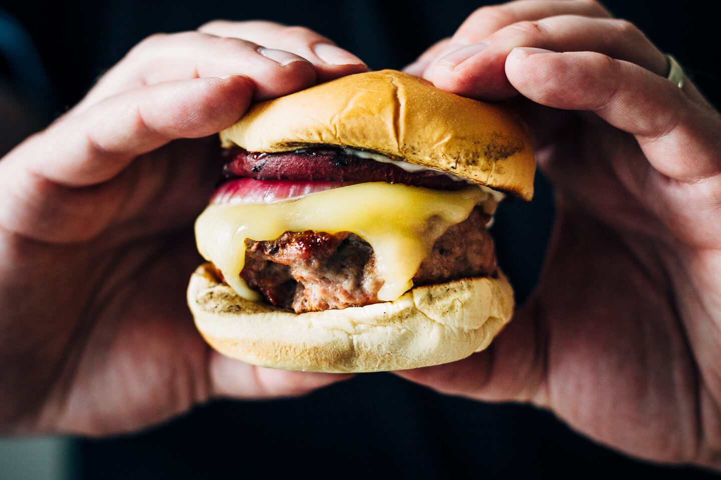 Juicy pork burgers perfectly grilled and topped with velvety melted Raclette cheese, grilled nectarine slices, crisp pickled red onions, and a smear of mayo.