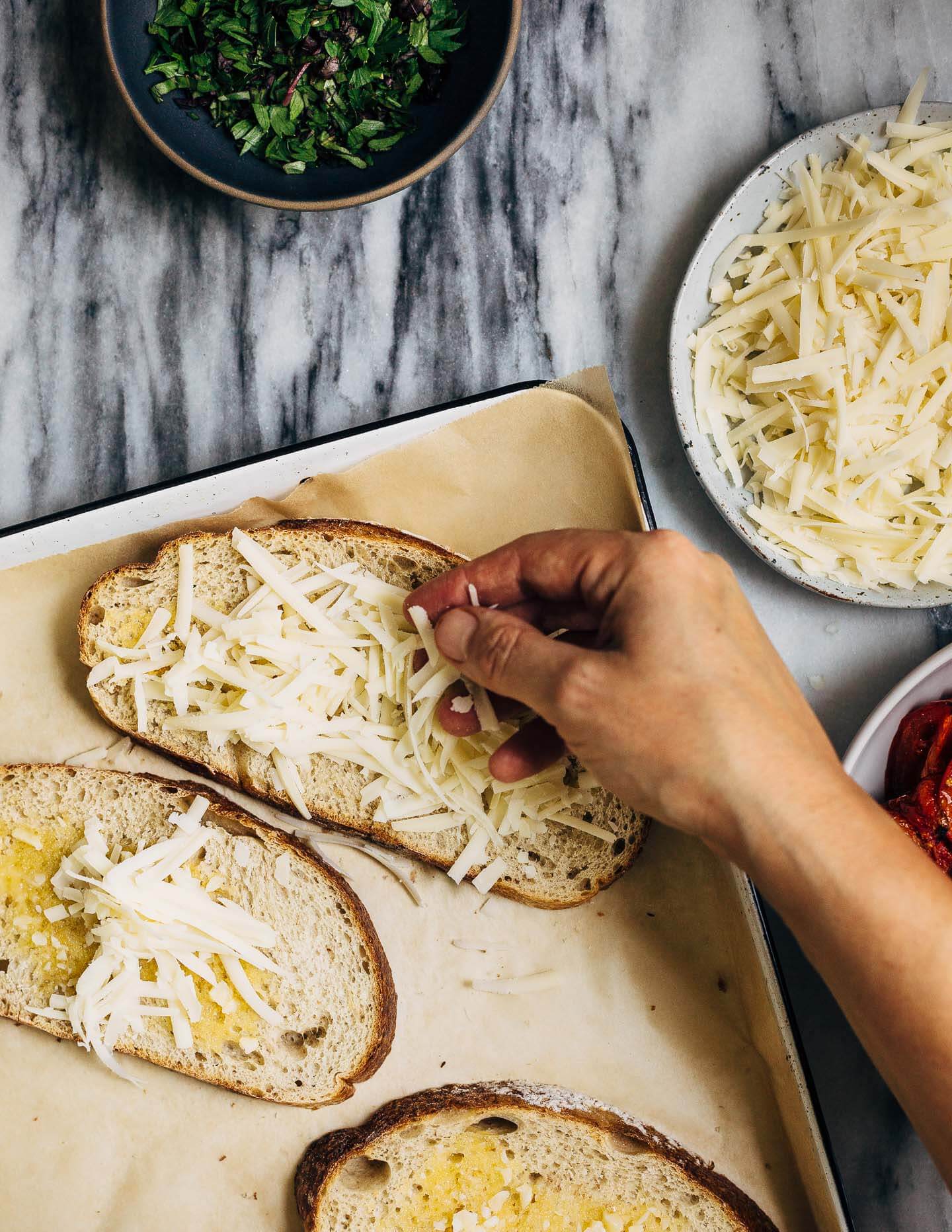 Celebrating the height of tomato season with sumptuous Gruyere and roasted tomato tartines made with thick-cut sourdough and punchy garlic butter.