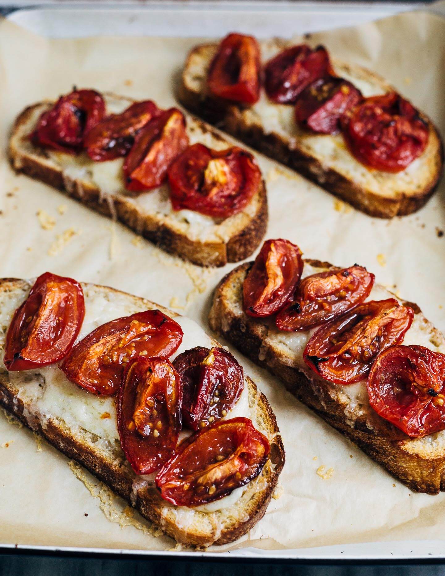 Celebrating the height of tomato season with sumptuous Gruyere and roasted tomato tartines made with thick-cut sourdough and punchy garlic butter.