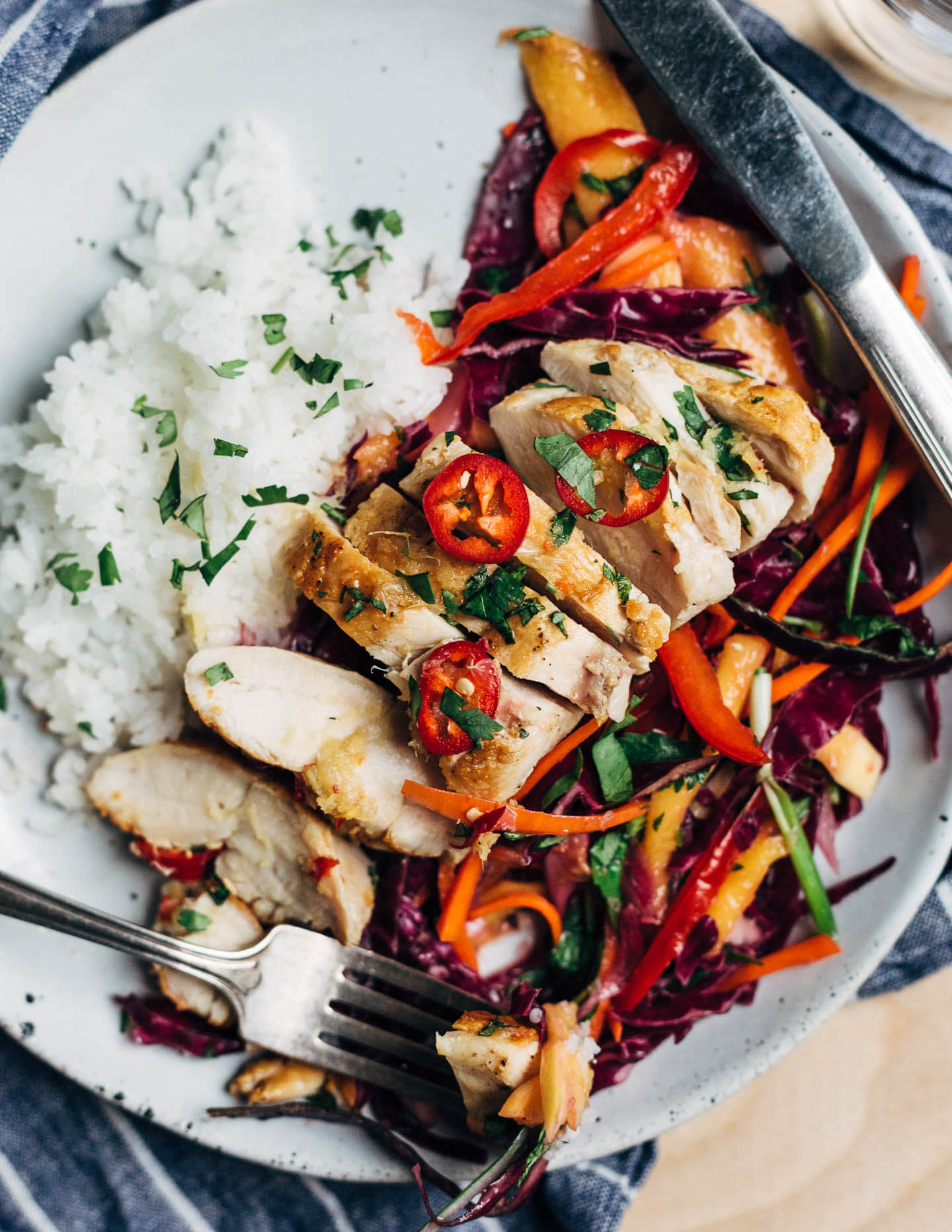 Inspired by Thai flavors, this meal prep chicken features juicy pan-seared chicken breast is served alongside a vibrant red cabbage and mango slaw and sticky jasmine rice.