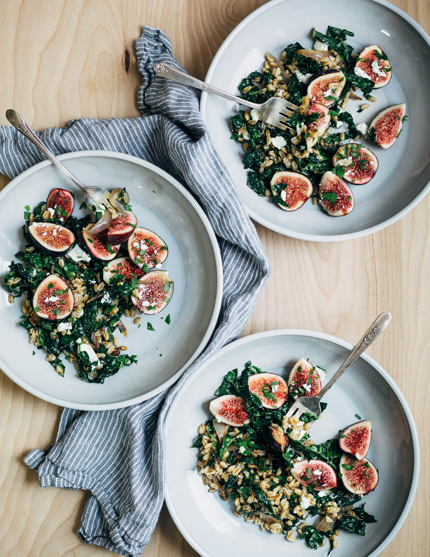 This nutty toasted farro salad features al dente farro tossed with massaged kale and ruby-hued fresh figs topped with creamy goat cheese crumbles and fresh parsley.