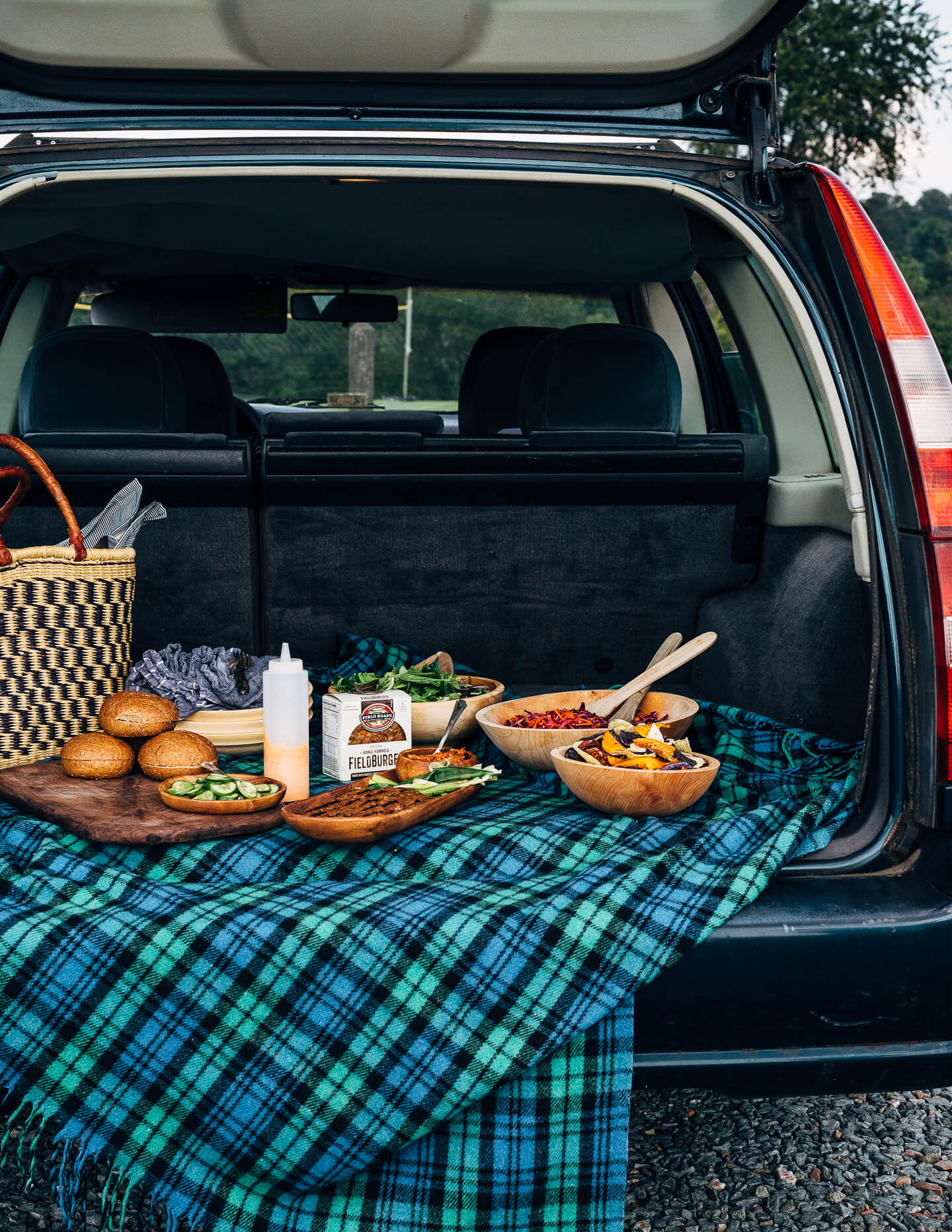 A fresh spin on the traditional tailgating party featuring plant-based kimchi burgers topped with grilled green onions and a spicy gochujang sunflower spread.