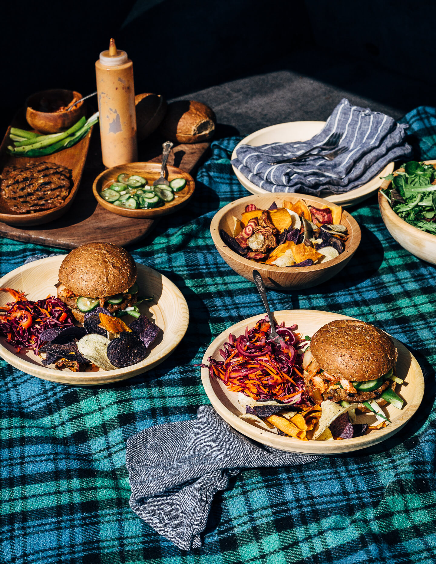 A fresh spin on the traditional tailgating party featuring plant-based kimchi burgers topped with grilled green onions and a spicy gochujang sunflower spread.