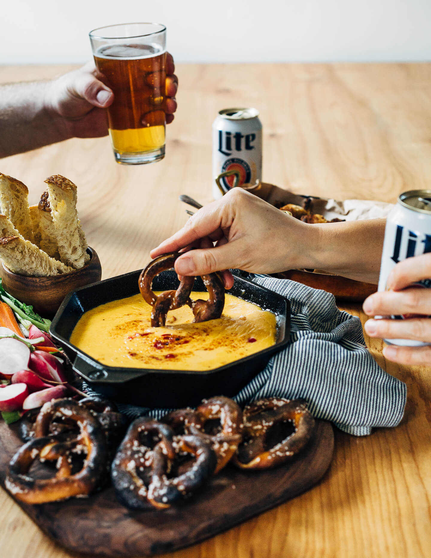 A simple, classic beer cheese recipe served alongside crispy fried cauliflower bites, toast soldiers, and crunchy dark pretzels.