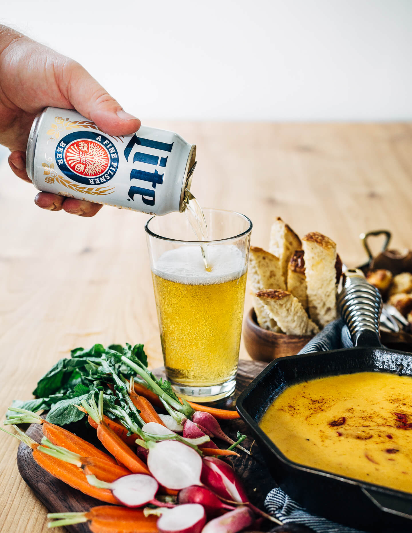 A simple, classic beer cheese recipe served alongside crispy fried cauliflower bites, toast soldiers, and crunchy dark pretzels.