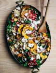 A vibrant, yet sturdy, pearl couscous and roasted delicata squash salad, tossed with tender kale, pomegranate arils, pepitas, and crumbled goat cheese, that's perfect as autumnal side dish or a versatile meal prep lunch.