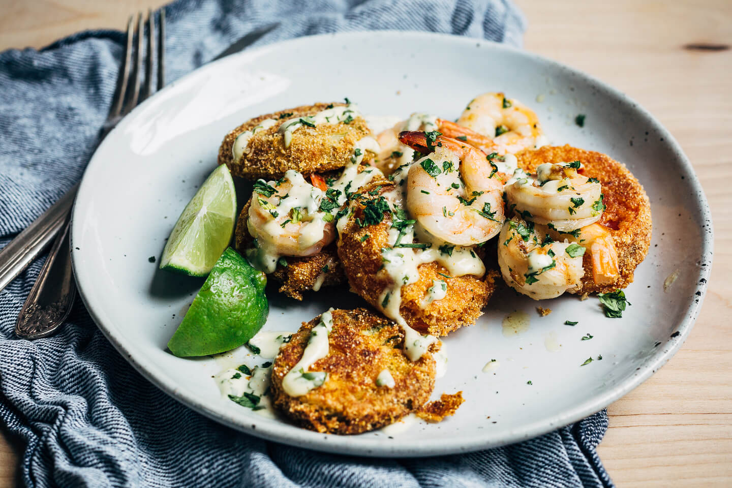 Putting leftover green tomatoes to good use with a recipe for crisp, savory fried green tomatoes topped with garlicky sautéed shrimp and a super simple remoulade.
