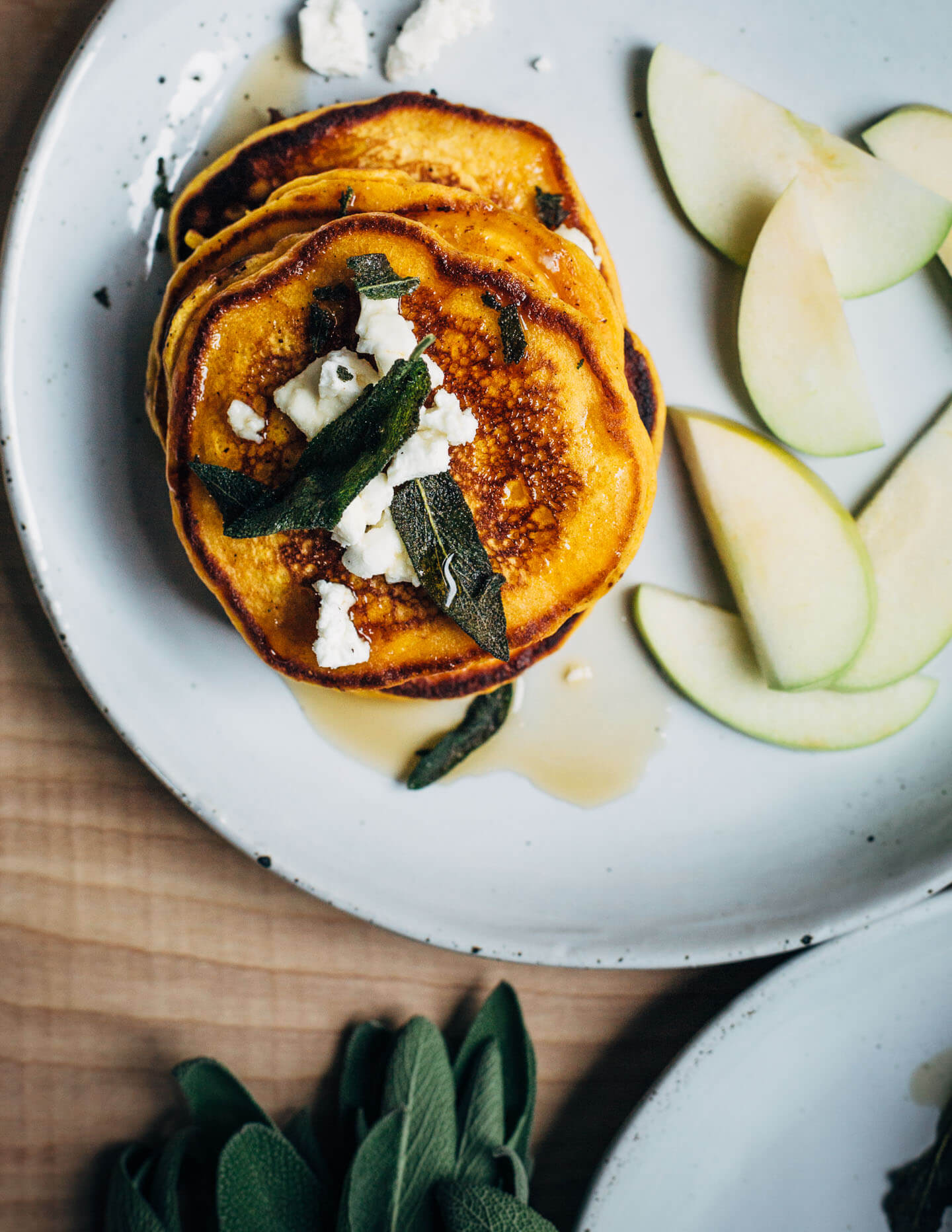 An autumnal sweet potato pancake recipe topped with fried sage leaves and crumbled goat cheese.