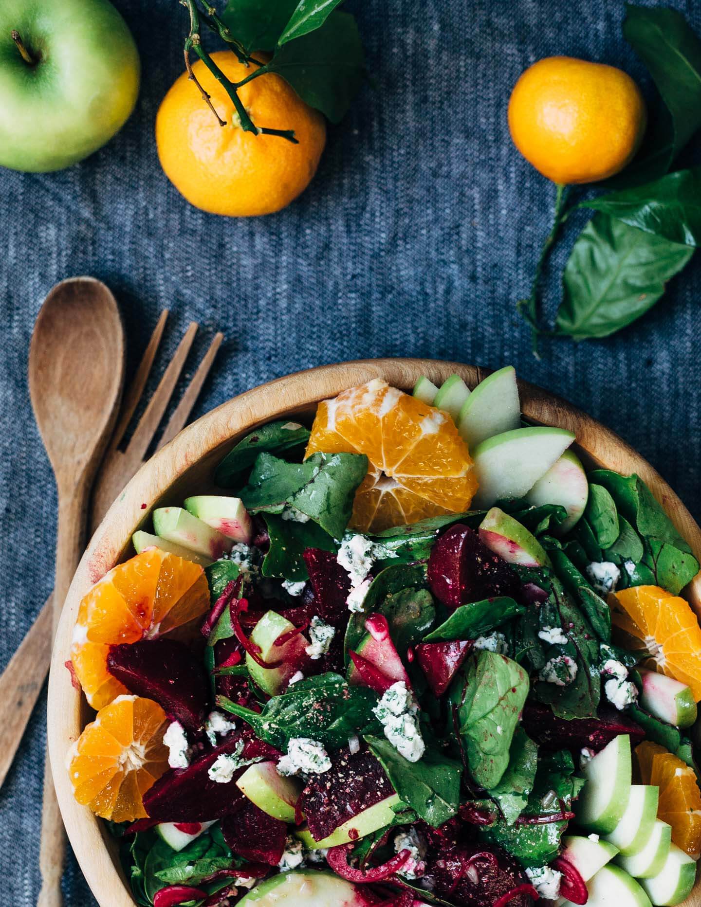 A bright and crunchy green apple and beet salad recipe featuring sliced green apples, marinated beets tossed with red wine vinegar and shallot, beet greens, spinach, herbed goat cheese crumbles, and a simple vinaigrette. 