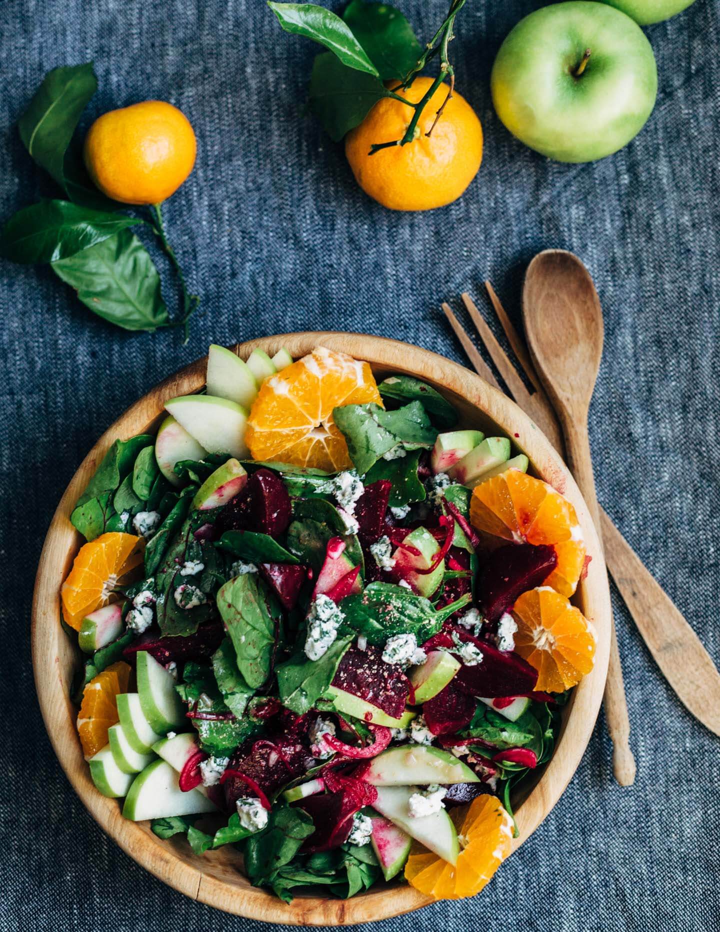 A bright and crunchy green apple and beet salad recipe featuring sliced green apples, marinated beets tossed with red wine vinegar and shallot, beet greens, spinach, herbed goat cheese crumbles, and a simple vinaigrette.