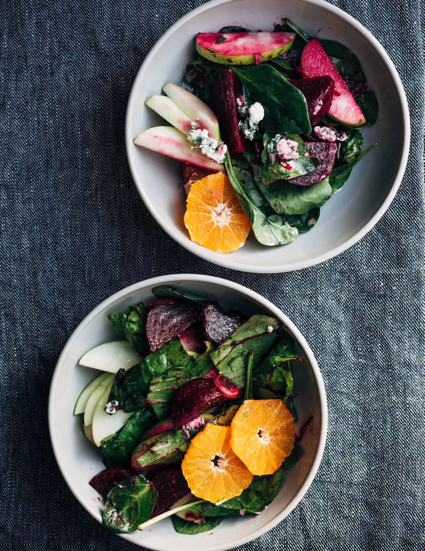 A bright and crunchy green apple and beet salad recipe featuring sliced green apples, marinated beets tossed with red wine vinegar and shallot, beet greens, spinach, herbed goat cheese crumbles, and a simple vinaigrette. 