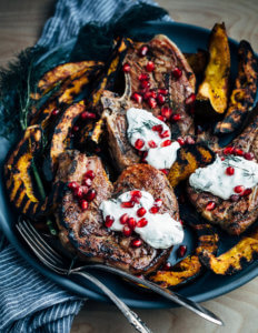 Add a pop of char and smoke to your Thanksgiving feast with this recipe for cumin-rubbed grilled lamb chops, grilled acorn squash wedges, dill and fennel tzatziki, and pomegranate arils.