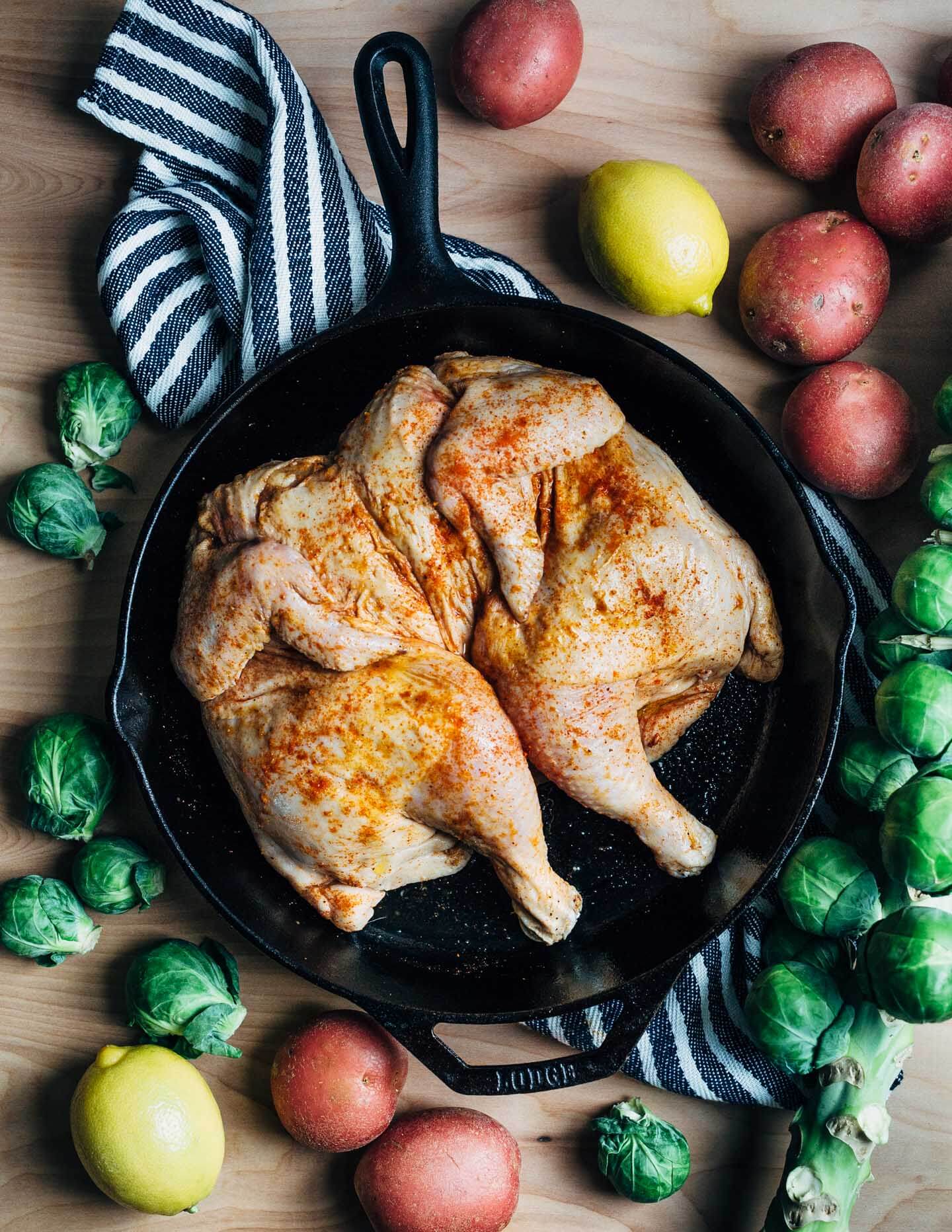 A simple and delicious holiday feast featuring crispy roasted spatchcock chicken with buttery sheet pan smashed potatoes and Brussels sprouts. 