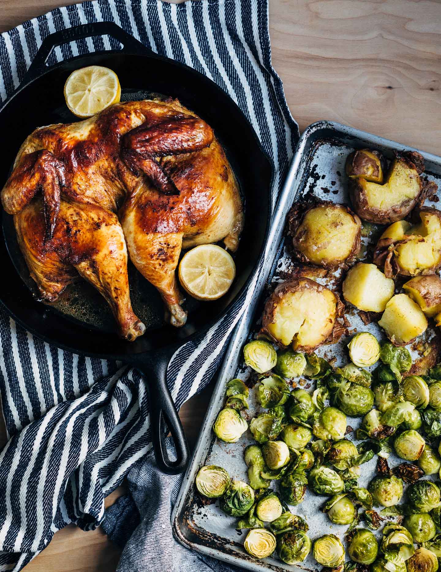 A simple and delicious holiday feast featuring crispy roasted spatchcock chicken with buttery sheet pan smashed potatoes and Brussels sprouts. 