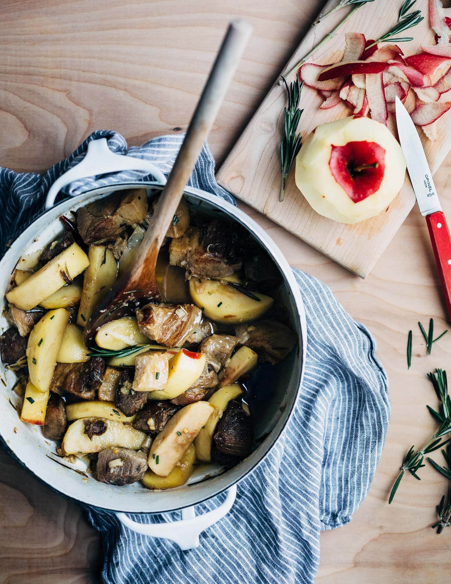 A simple and savory wintry stew featuring braised pork with apples, rosemary, chilies, and citrus served over polenta. 