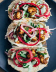 These easy (and delicious!) shrimp tacos feature pan-seared shrimp tossed with lots of chili, cumin, and garlic powder, a simple winter slaw made with watermelon radishes and jicama, and a quick cilantro-yogurt blender sauce. 