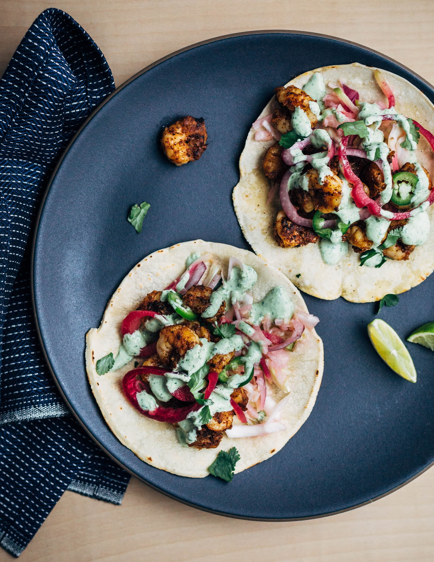 These easy (and delicious!) shrimp tacos feature pan-seared shrimp tossed with lots of chili, cumin, and garlic powder, a simple winter slaw made with watermelon radishes and jicama, and a quick cilantro-yogurt blender sauce. 