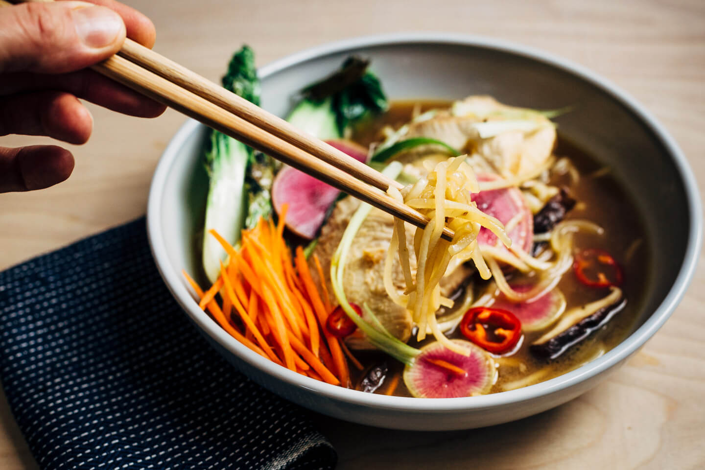 A restorative turnip noodle ramen recipe featuring tender turnip noodles and a host of winter vegetables served in a rich ramen broth topped with juicy, flavorful steamed chicken breasts. Recipe is naturally gluten-free and includes a simple Whole30-compliant variation.