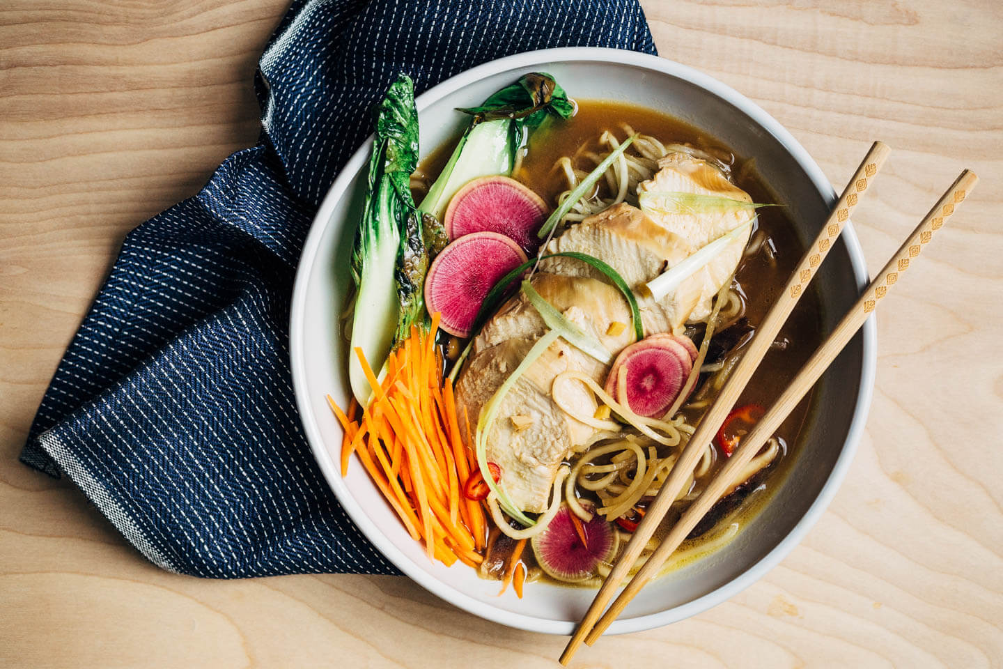 A restorative turnip noodle ramen recipe featuring tender turnip noodles and a host of winter vegetables served in a rich ramen broth topped with juicy, flavorful steamed chicken breasts. Recipe is naturally gluten-free and includes a simple Whole30-compliant variation.