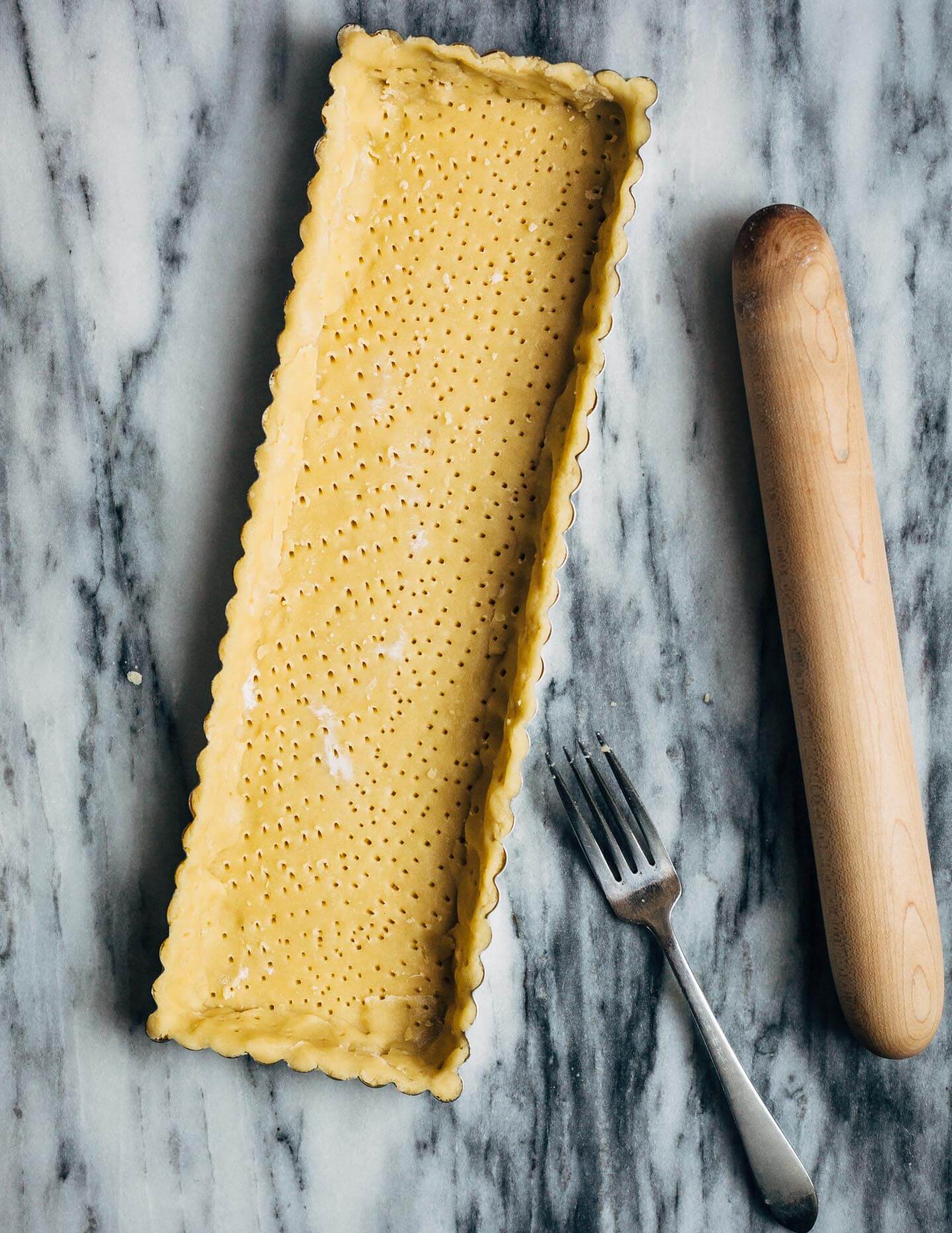 A bright and creamy grapefruit curd tart baked up in a classic pâte sucrée crust that's perfect for celebratory winter meals.