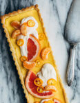 A bright and creamy grapefruit curd tart baked up in a classic pâte sucrée crust that's perfect for celebratory winter meals.