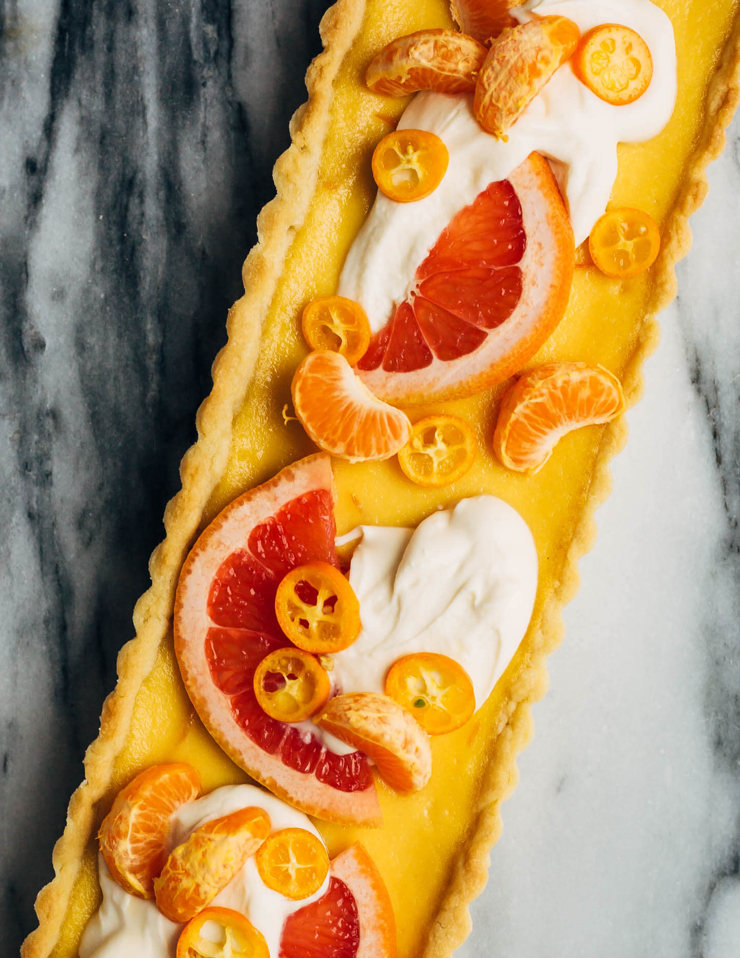 A bright and creamy grapefruit curd tart baked up in a classic pâte sucrée crust that's perfect for celebratory winter meals.