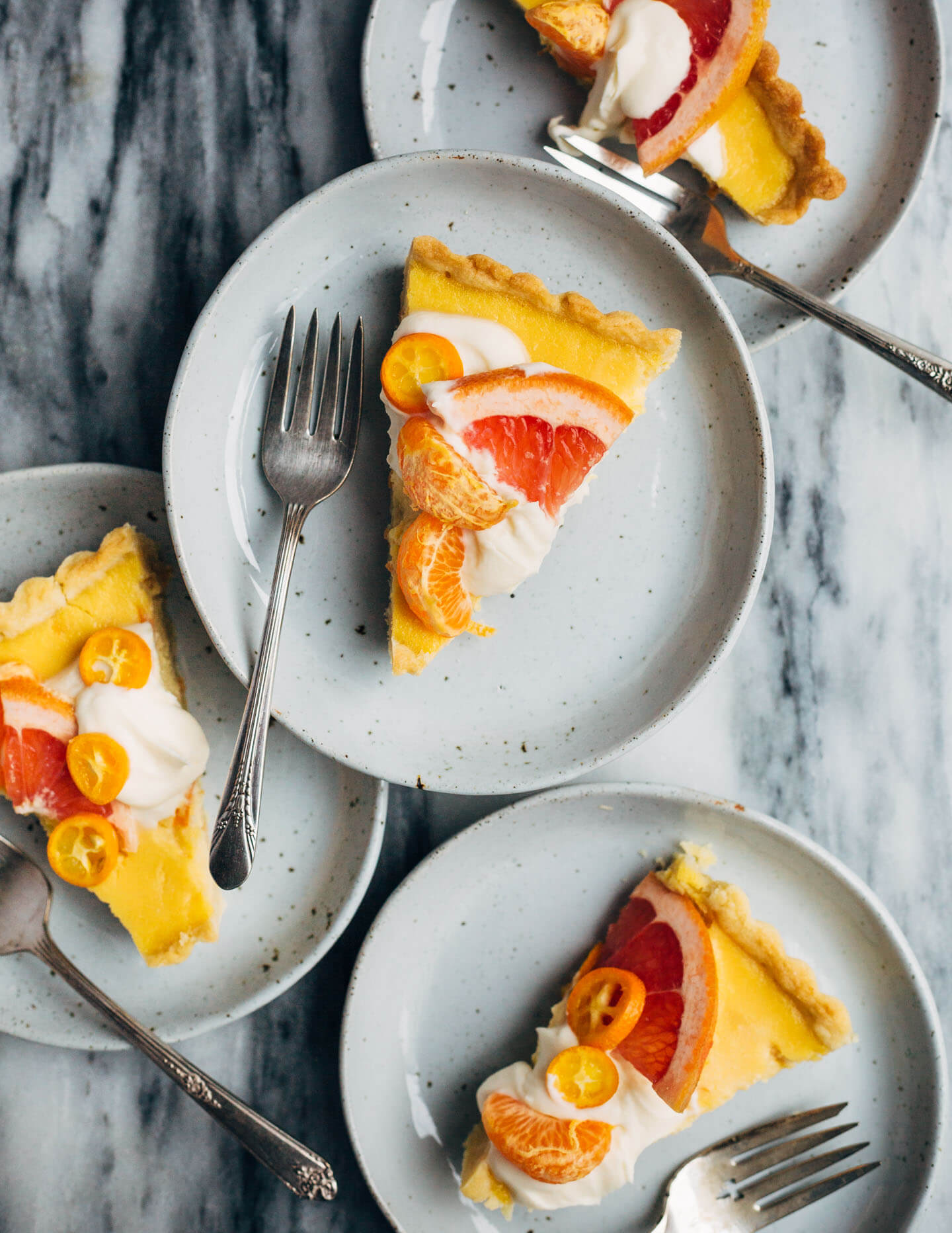A bright and creamy grapefruit curd tart baked up in a classic pâte sucrée crust that's perfect for celebratory winter meals.