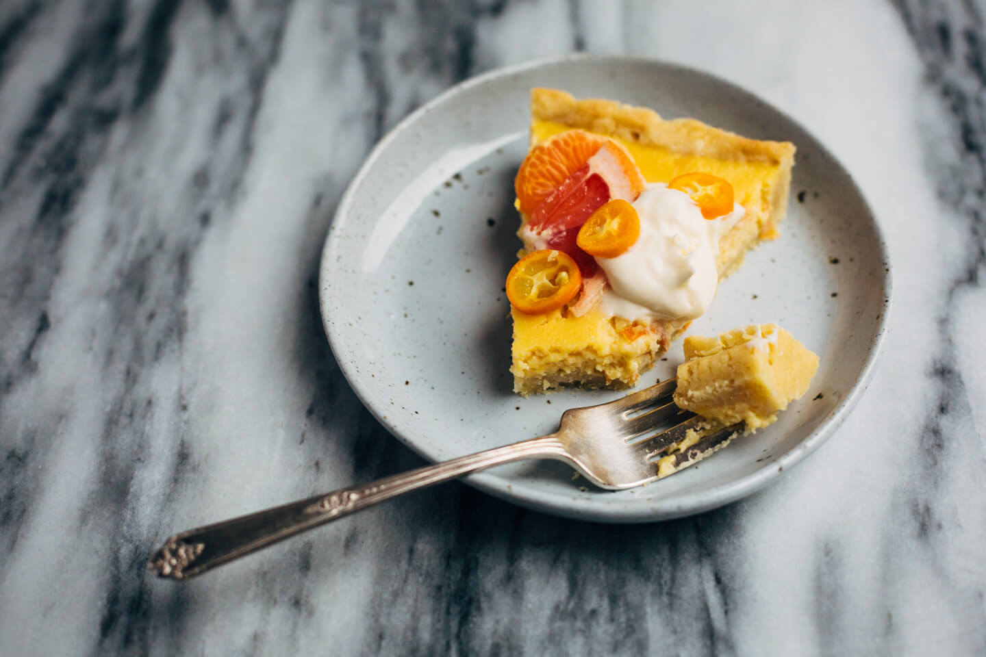 A bright and creamy grapefruit curd tart baked up in a classic pâte sucrée crust that's perfect for celebratory winter meals.