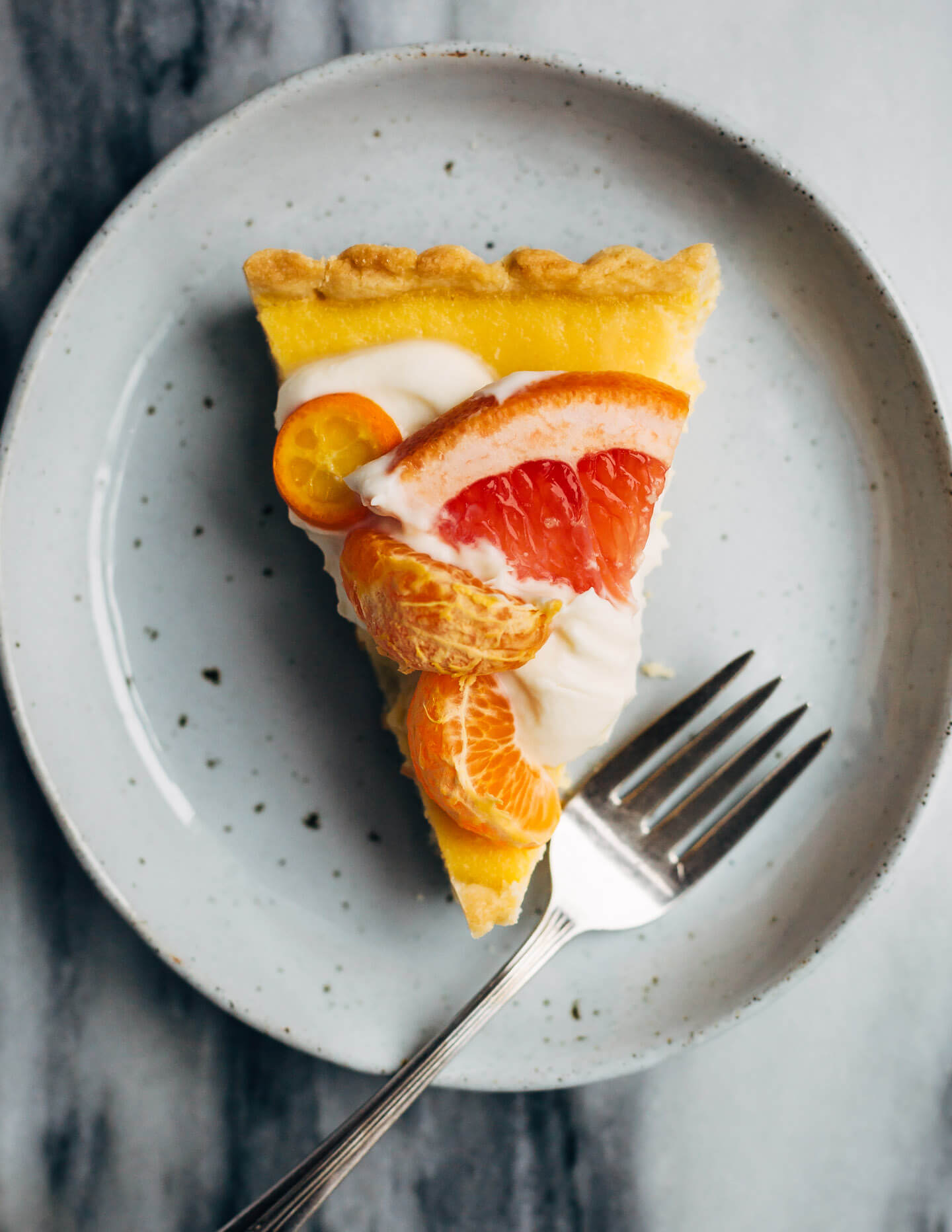 A bright and creamy grapefruit curd tart baked up in a classic pâte sucrée crust that's perfect for celebratory winter meals.