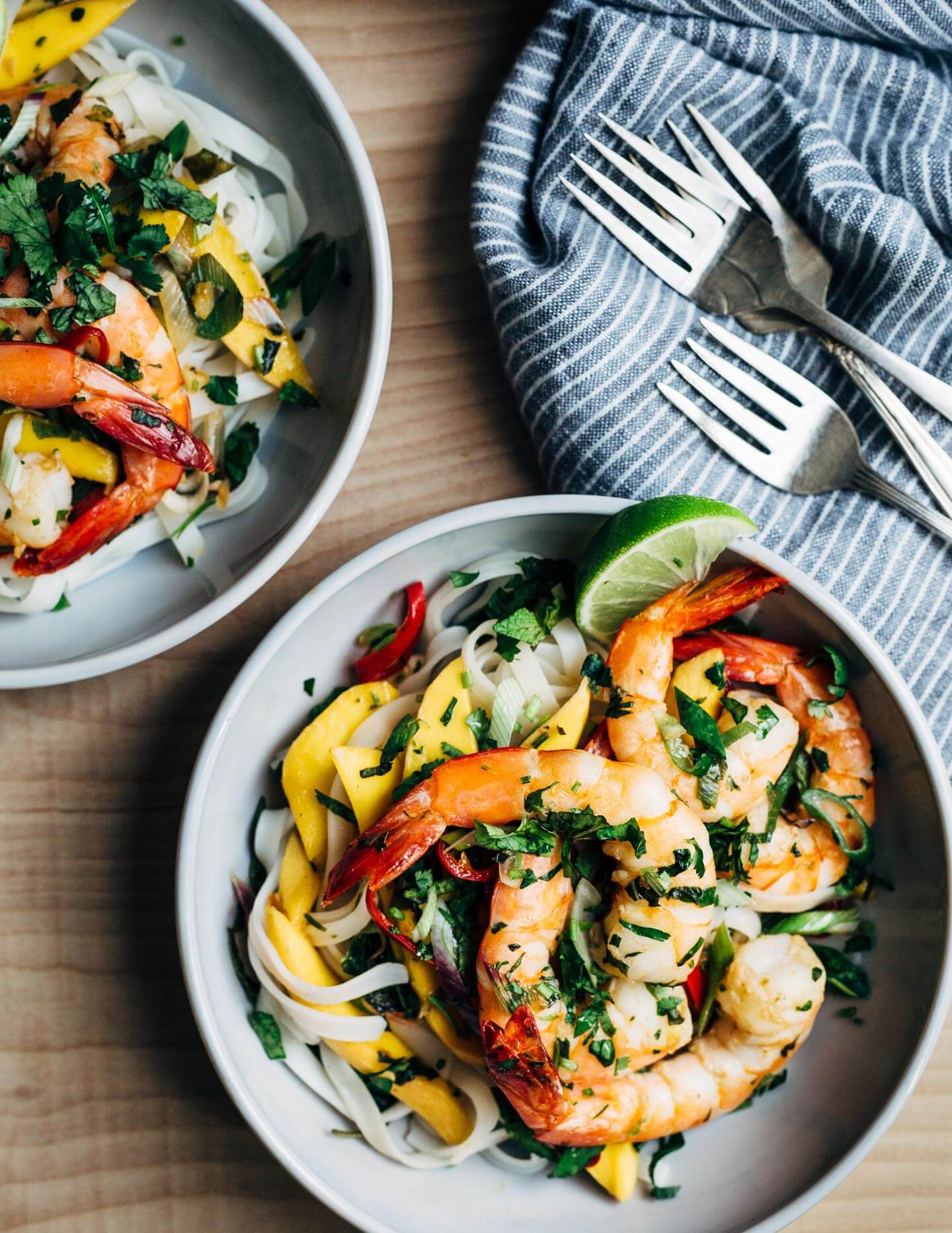 Mango shrimp is perfect for busy nights. Fresh sliced mango and shrimp seared in coconut oil tossed with chilis, herbs, rice noodles, and a simple lime sauce makes for a nearly effortless, crazy flavorful weeknight meal.