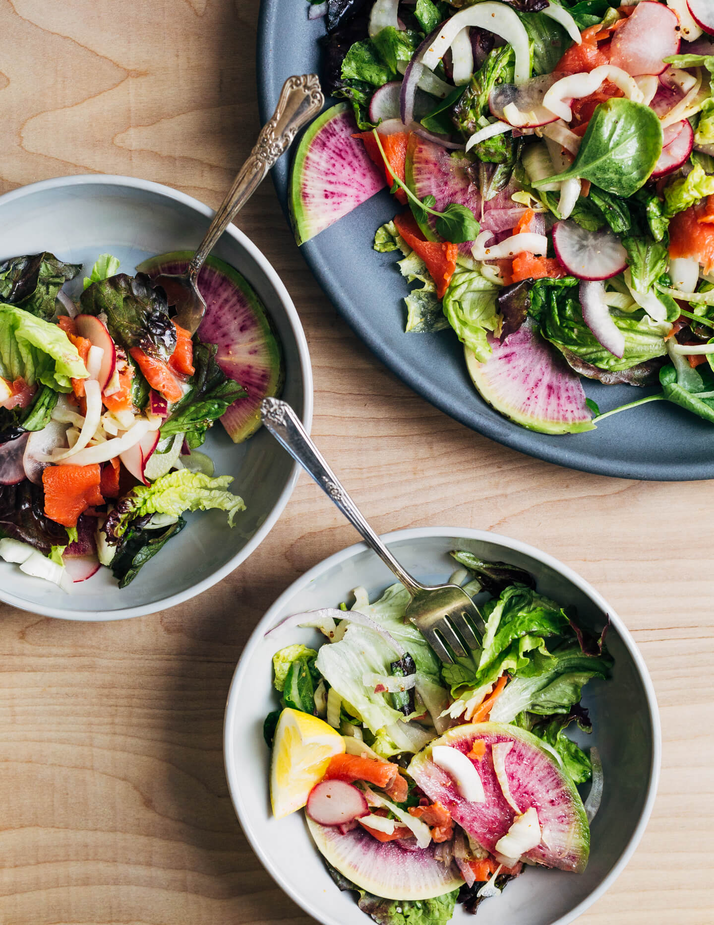 A colorful smoked salmon salad to herald spring! Smoked salmon and delicate lettuces are layered with thinly sliced fennel, radish, and red onion, and tossed with an assertive Dijon and horseradish vinaigrette. 