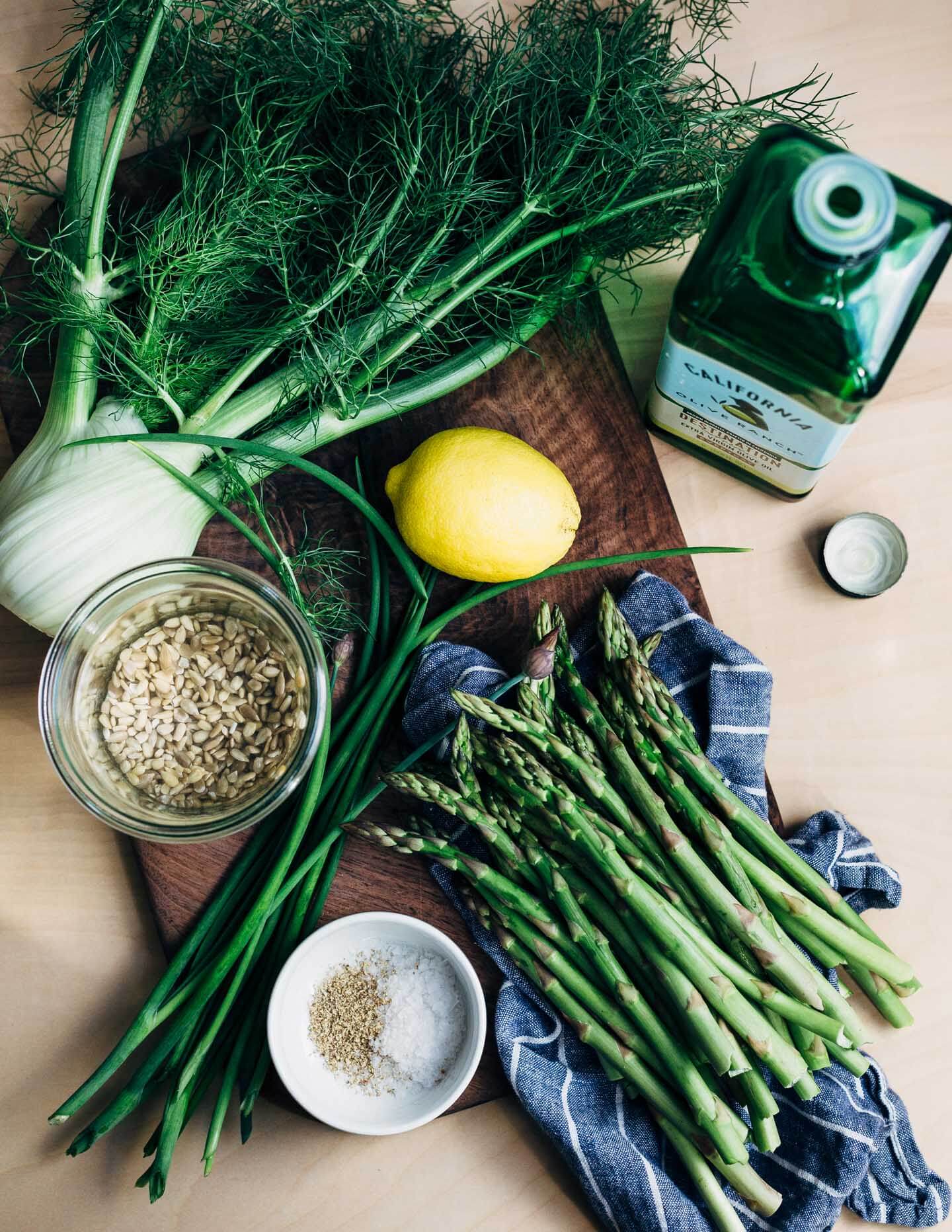 A creamy, mild asparagus pesto that tastes like spring! Made with garden chives, soaked sunflower seeds, and Parmesan, it's perfect served alongside broiled salmon and lemony fennel slaw. 