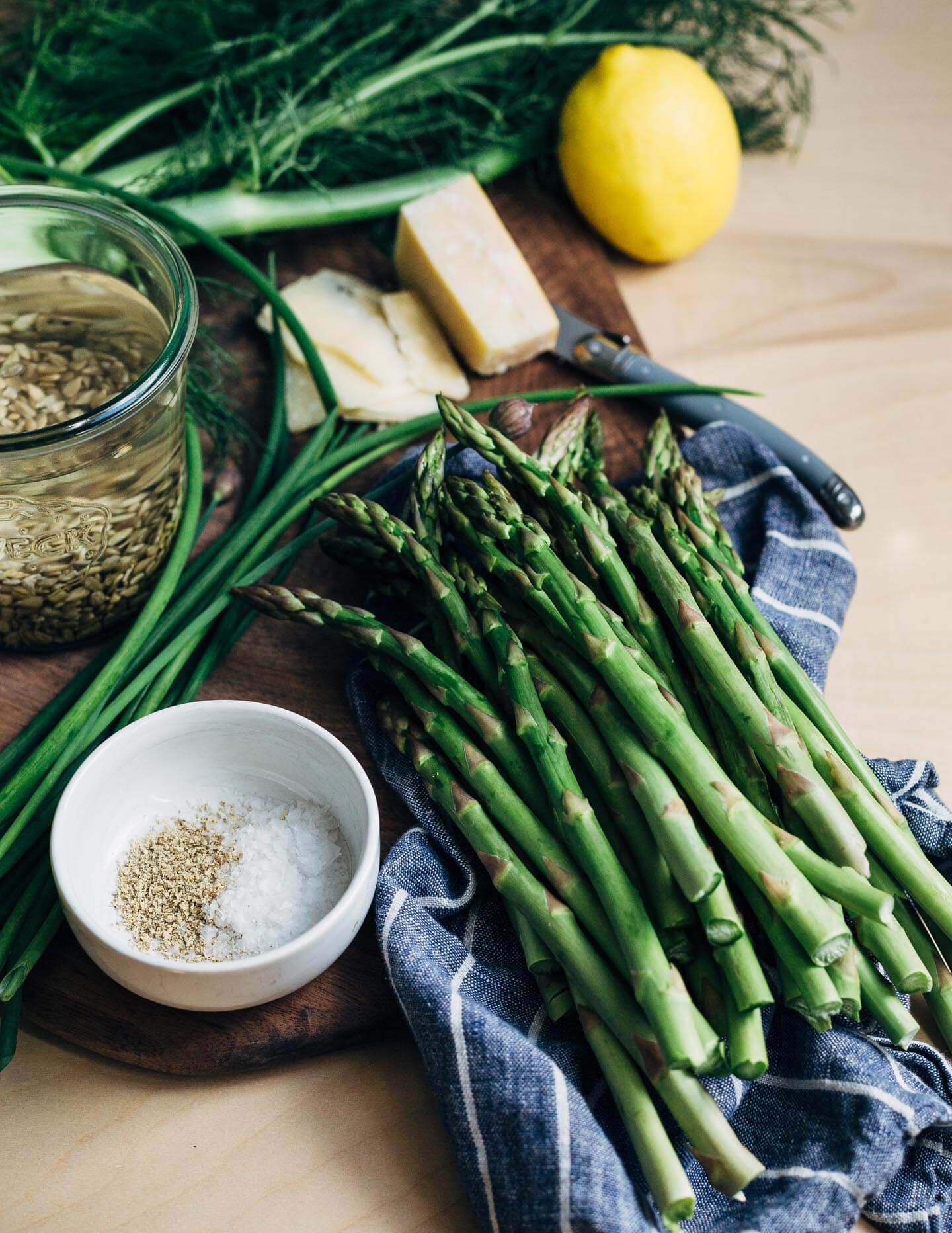 A creamy, mild asparagus pesto that tastes like spring! Made with garden chives, soaked sunflower seeds, and Parmesan, it's perfect served alongside broiled salmon and lemony fennel slaw. 