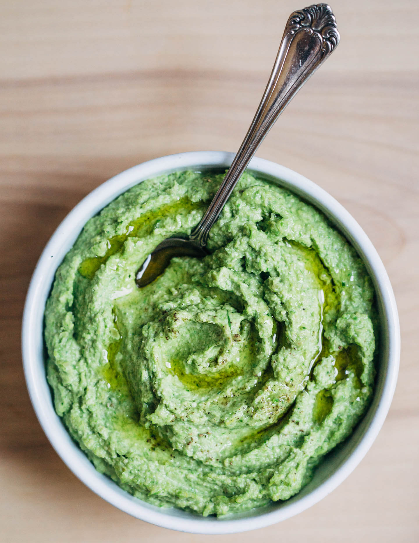 A creamy, mild asparagus pesto that tastes like spring! Made with garden chives, soaked sunflower seeds, and Parmesan, it's perfect served alongside broiled salmon and lemony fennel slaw. 