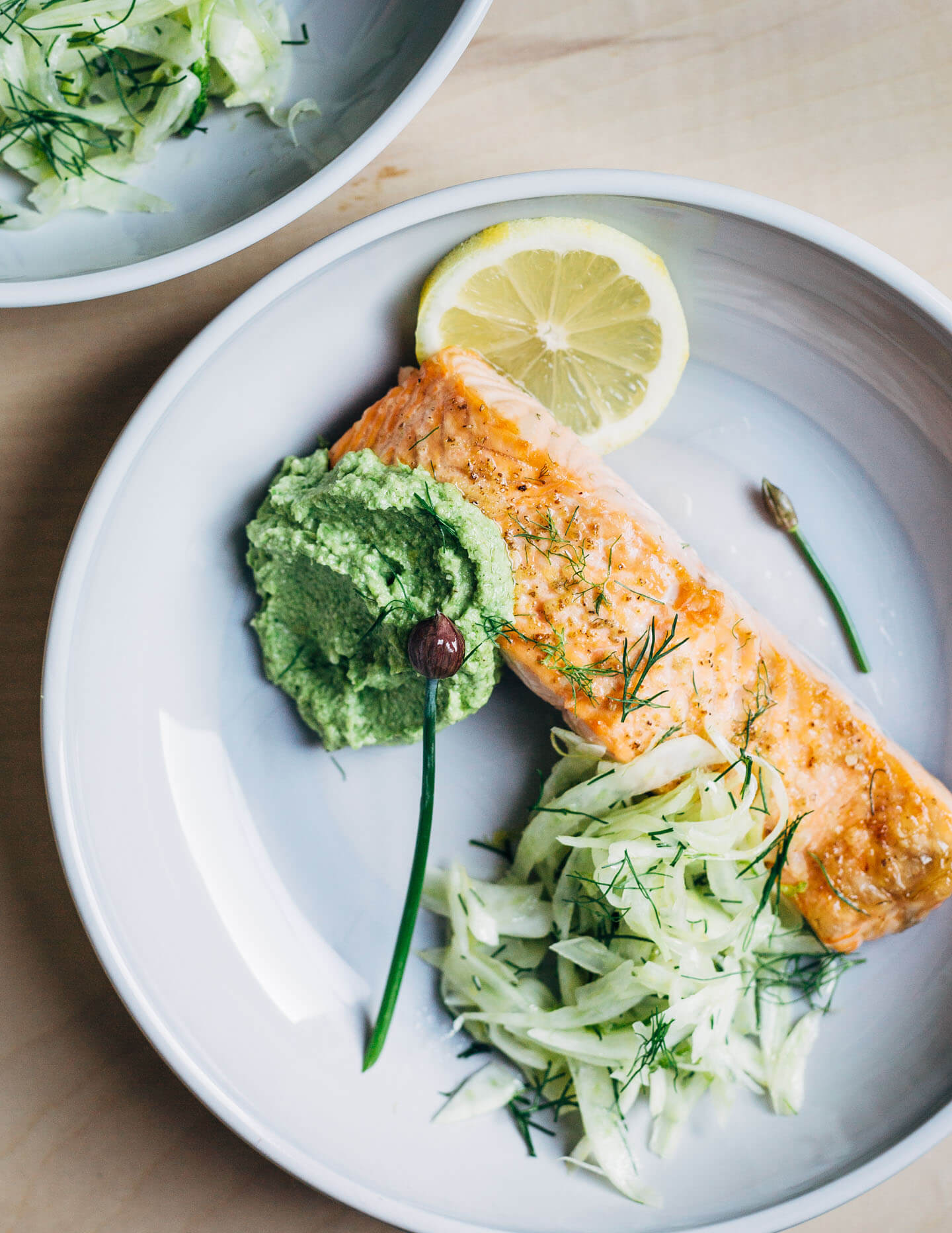 A creamy, mild asparagus pesto that tastes like spring! Made with garden chives, soaked sunflower seeds, and Parmesan, it's perfect served alongside broiled salmon and lemony fennel slaw. 