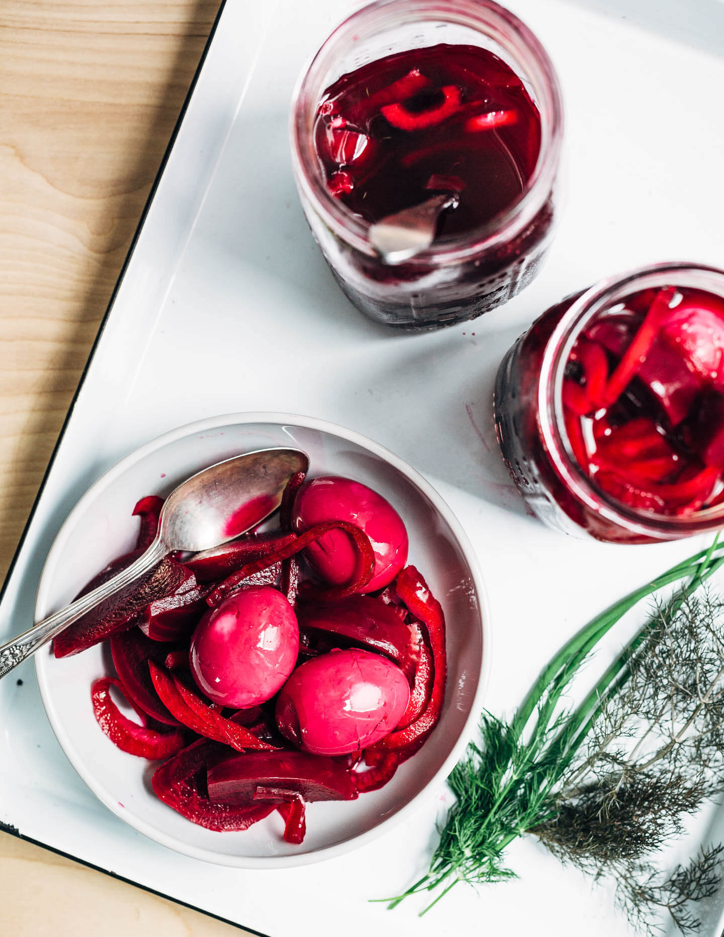 Extremely pink beet-pickled eggs aren't just beautiful, they're suffused with a richly flavored sweet and sour brine that pops with every bite. Serve the eggs alongside the pickled beets and red onions, and top with a dollop of sour cream and horseradish sauce and fresh garden herbs.