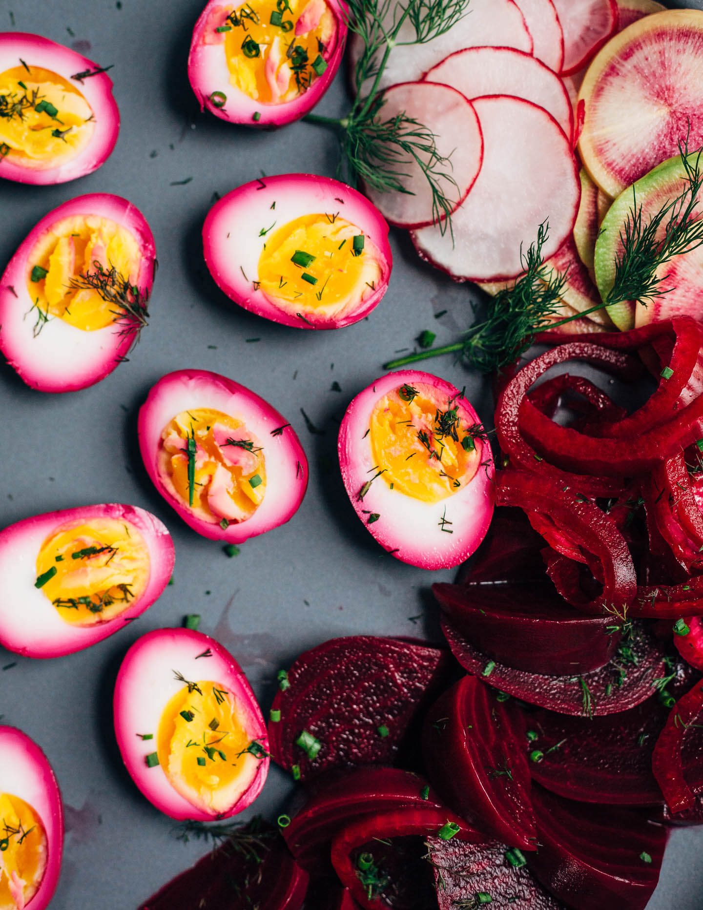 Extremely pink beet-pickled eggs aren't just beautiful, they're suffused with a richly flavored sweet and sour brine that pops with every bite. Serve the eggs alongside the pickled beets and red onions, and top with a dollop of sour cream and horseradish sauce and fresh garden herbs.