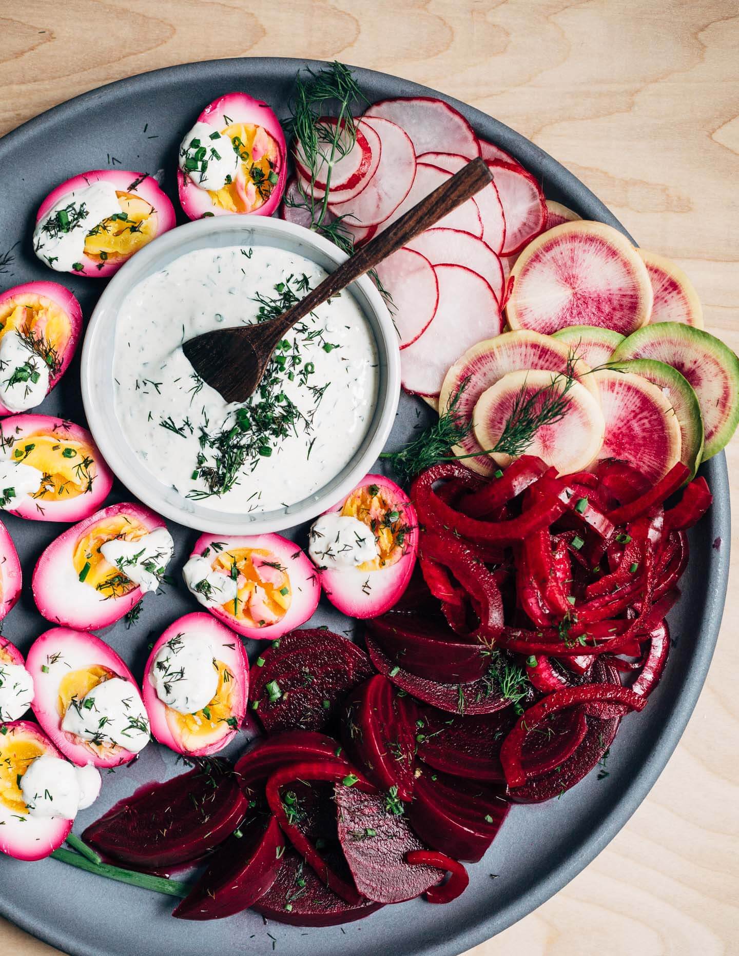 Extremely pink beet-pickled eggs aren't just beautiful, they're suffused with a richly flavored sweet and sour brine that pops with every bite. Serve the eggs alongside the pickled beets and red onions, and top with a dollop of sour cream and horseradish sauce and fresh garden herbs.