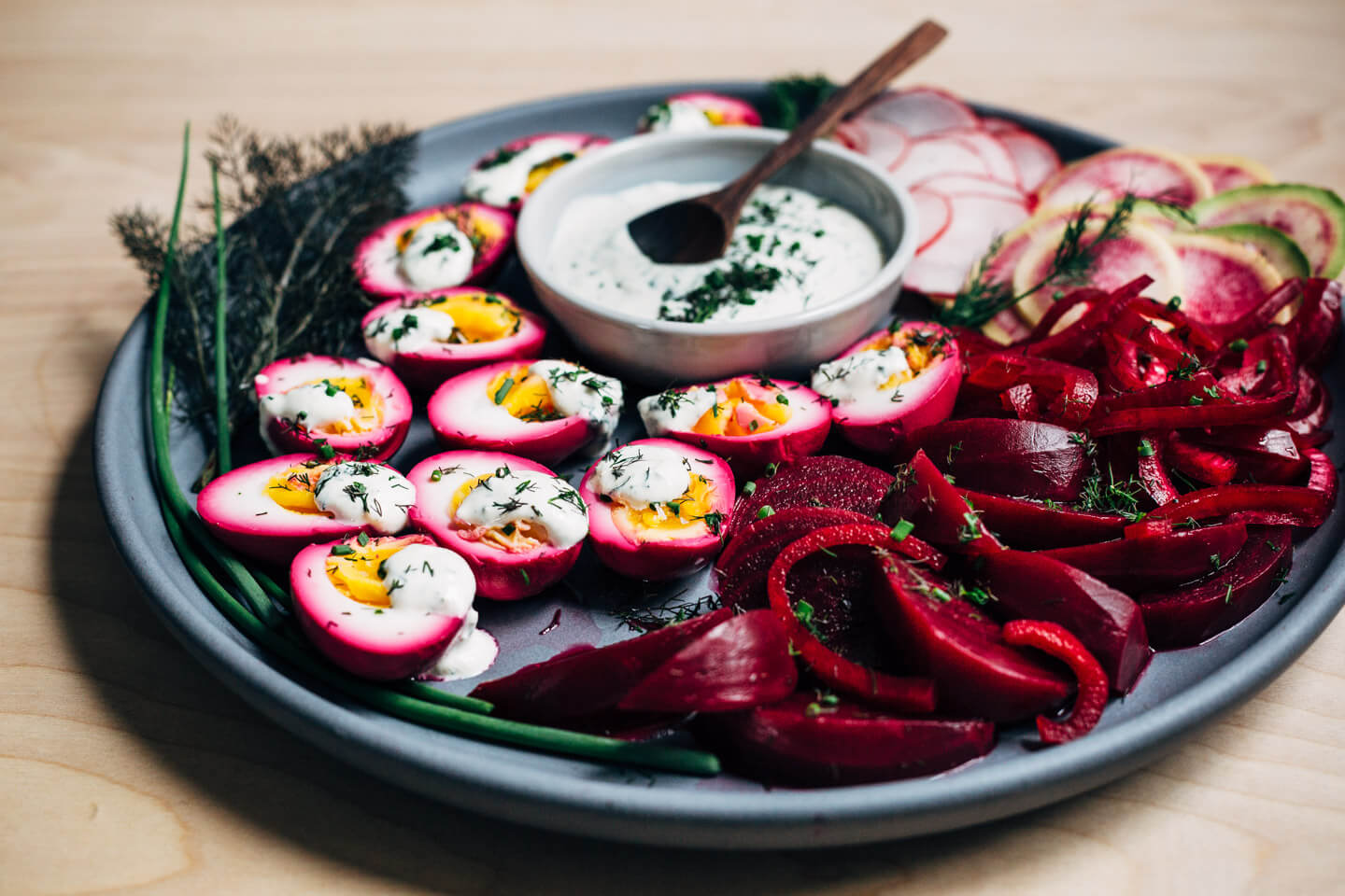 Extremely pink beet-pickled eggs aren't just beautiful, they're suffused with a richly flavored sweet and sour brine that pops with every bite. Serve the eggs alongside the pickled beets and red onions, and top with a dollop of sour cream and horseradish sauce and fresh garden herbs.