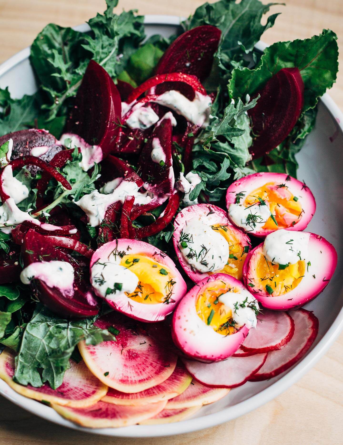 Extremely pink beet-pickled eggs aren't just beautiful, they're suffused with a richly flavored sweet and sour brine that pops with every bite. Serve the eggs alongside the pickled beets and red onions, and top with a dollop of sour cream and horseradish sauce and fresh garden herbs.