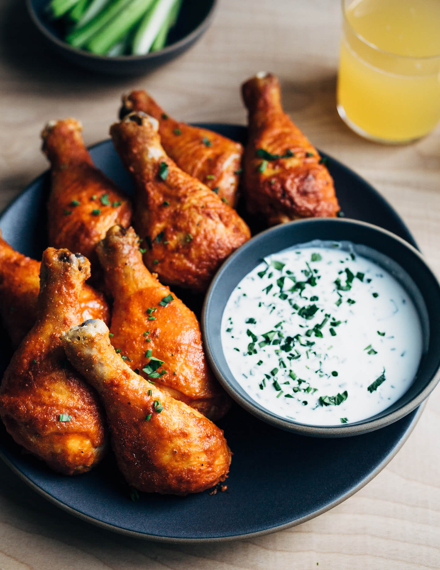 Hearty oven-roasted Buffalo chicken drumsticks with buttermilk ranch dressing and celery sticks are the perfect meal for spring and summer celebrations and gatherings.