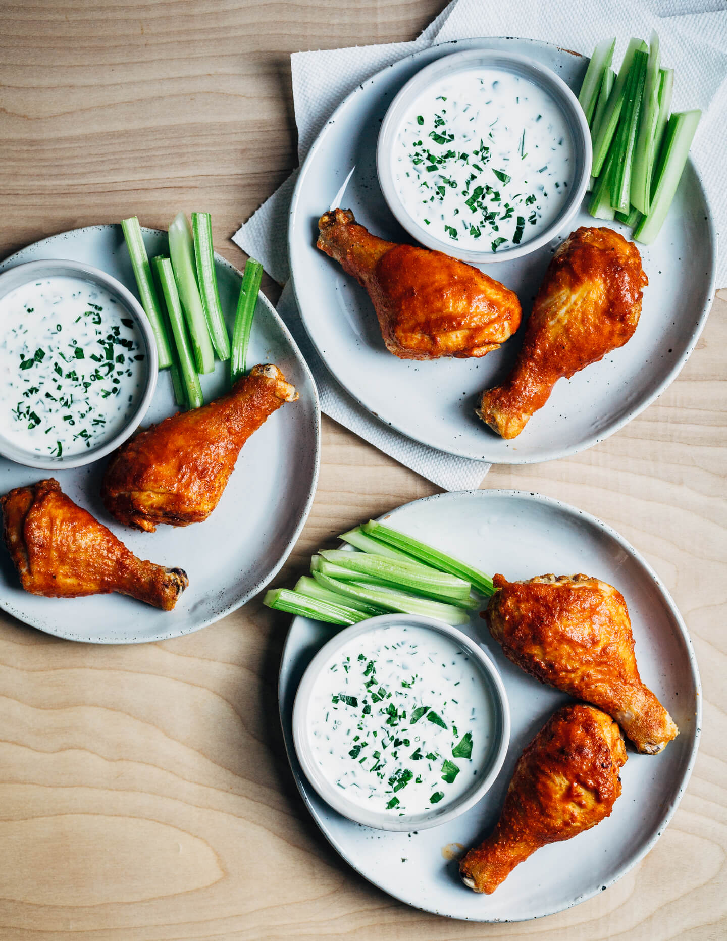 Hearty oven-roasted Buffalo chicken drumsticks with buttermilk ranch dressing and celery sticks are the perfect meal for spring and summer celebrations and gatherings.
