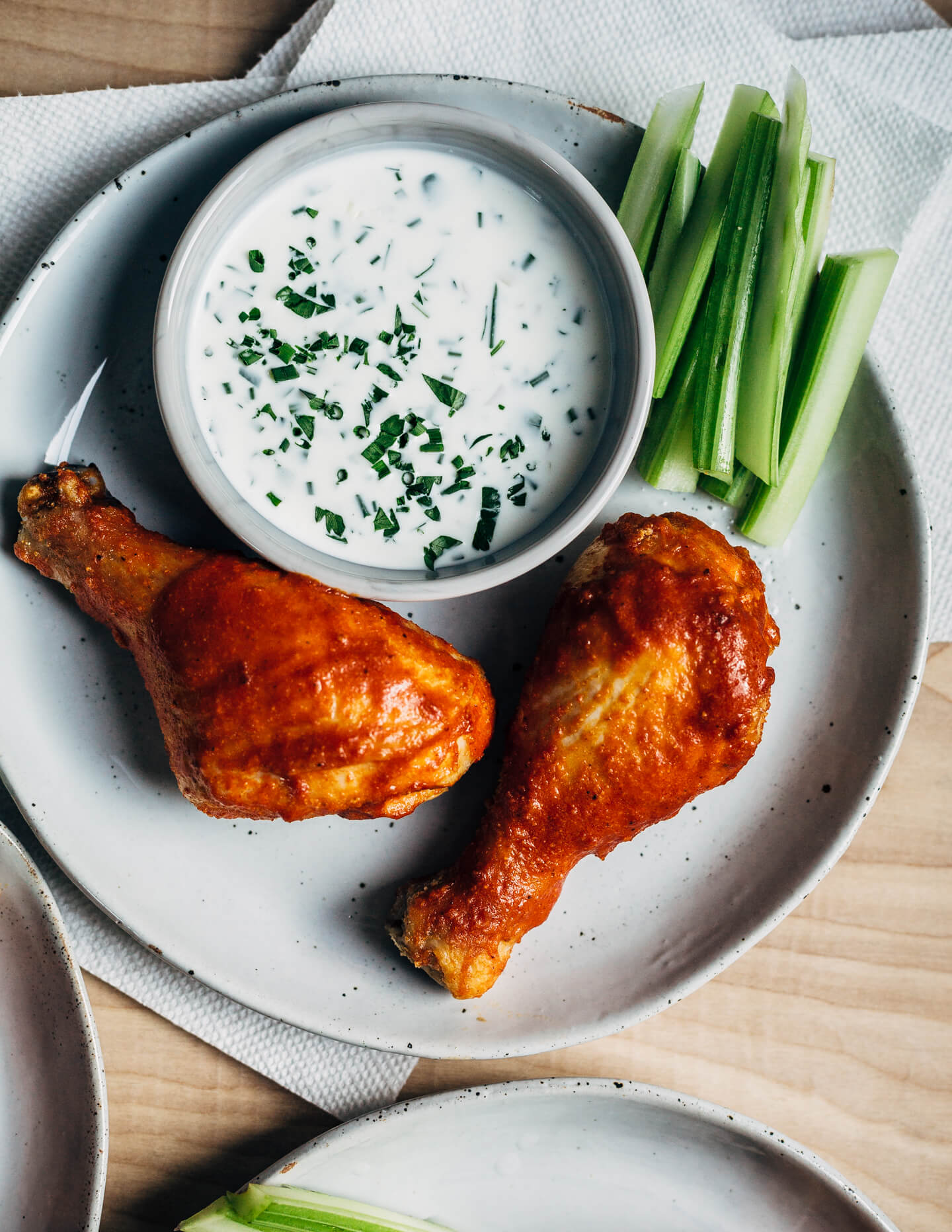 Hearty oven-roasted Buffalo chicken drumsticks with buttermilk ranch dressing and celery sticks are the perfect meal for spring and summer celebrations and gatherings.