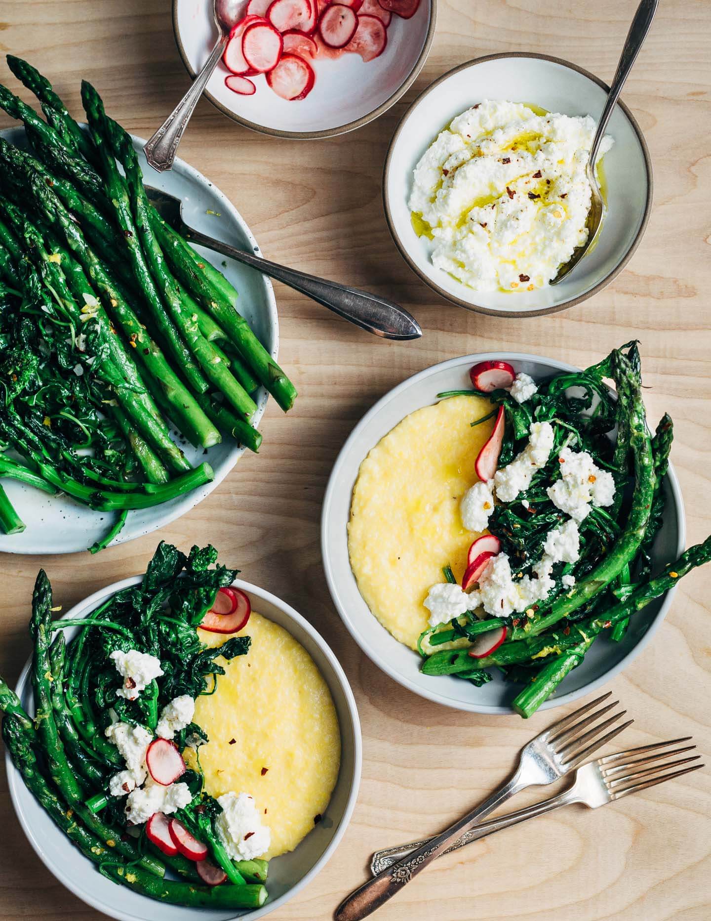 These versatile asparagus polenta bowls are a study in contrasting flavors and textures. Buttery polenta counters the bitter notes of spring greens and asparagus, while creamy ricotta tempers the heat of red pepper flakes and young garlic. 