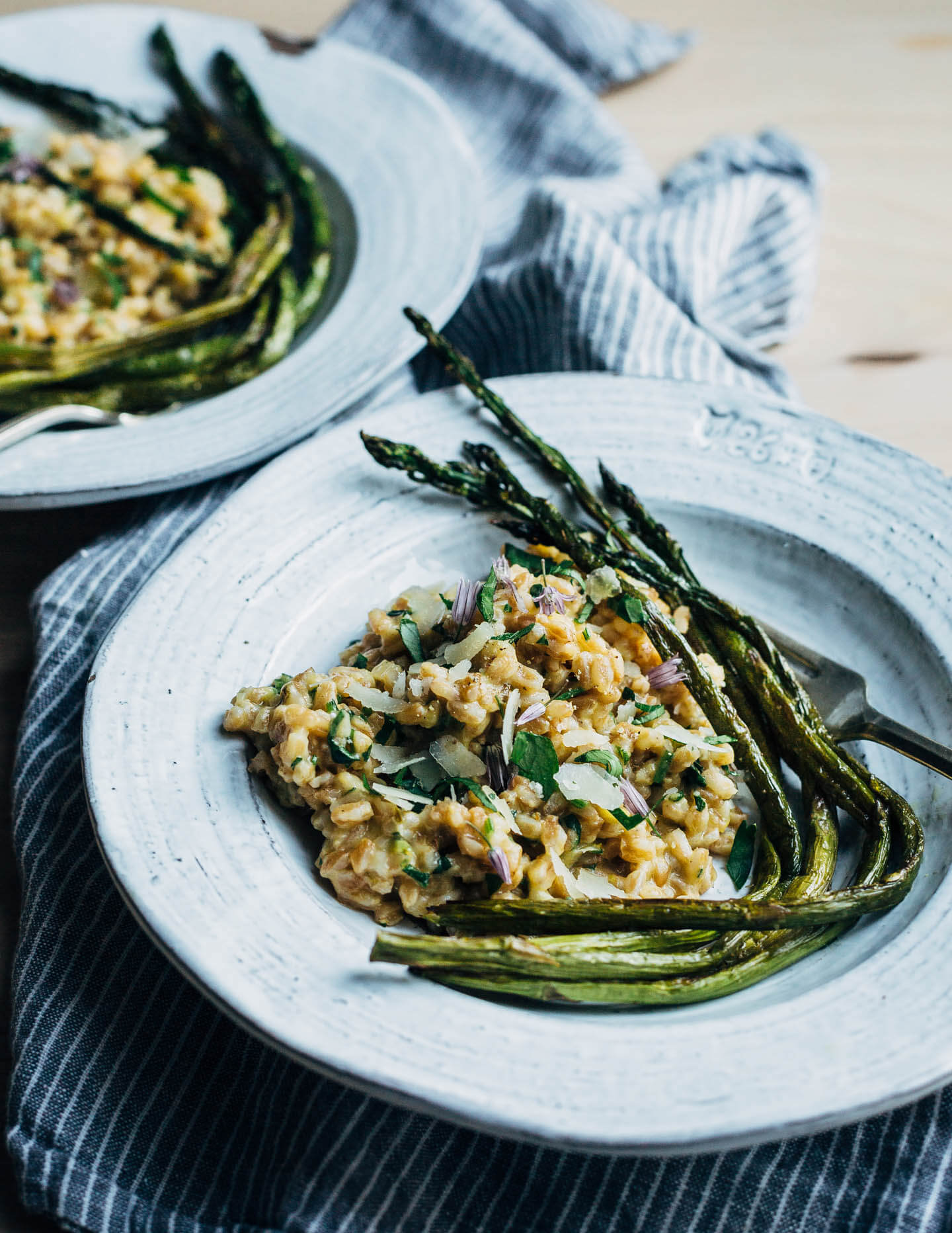 Creamy farro risotto (aka farrotto) with all the best spring things like ramps, young garlic, chives, and roasted asparagus. 