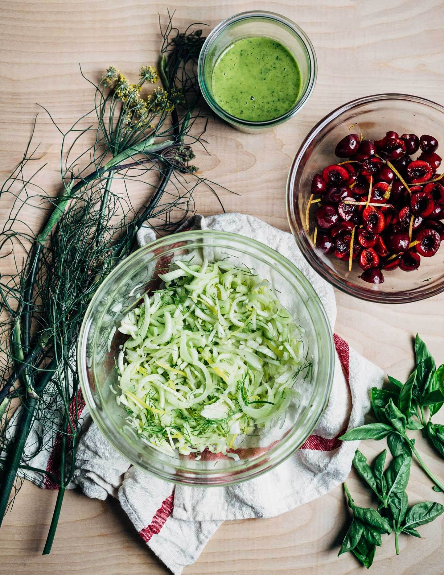 Ingredient prep for a shaved fennel and sweet Bing cherry Caprese salad. 