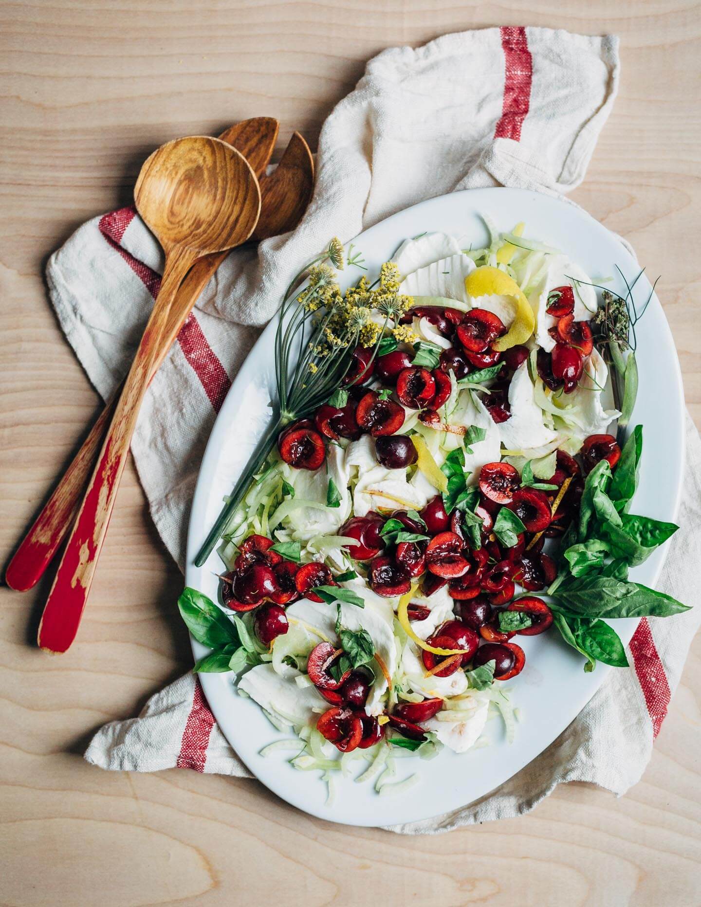 An unconventional Bing cherry Caprese salad recipe with shaved fennel and a fresh basil and green onion dressing. 