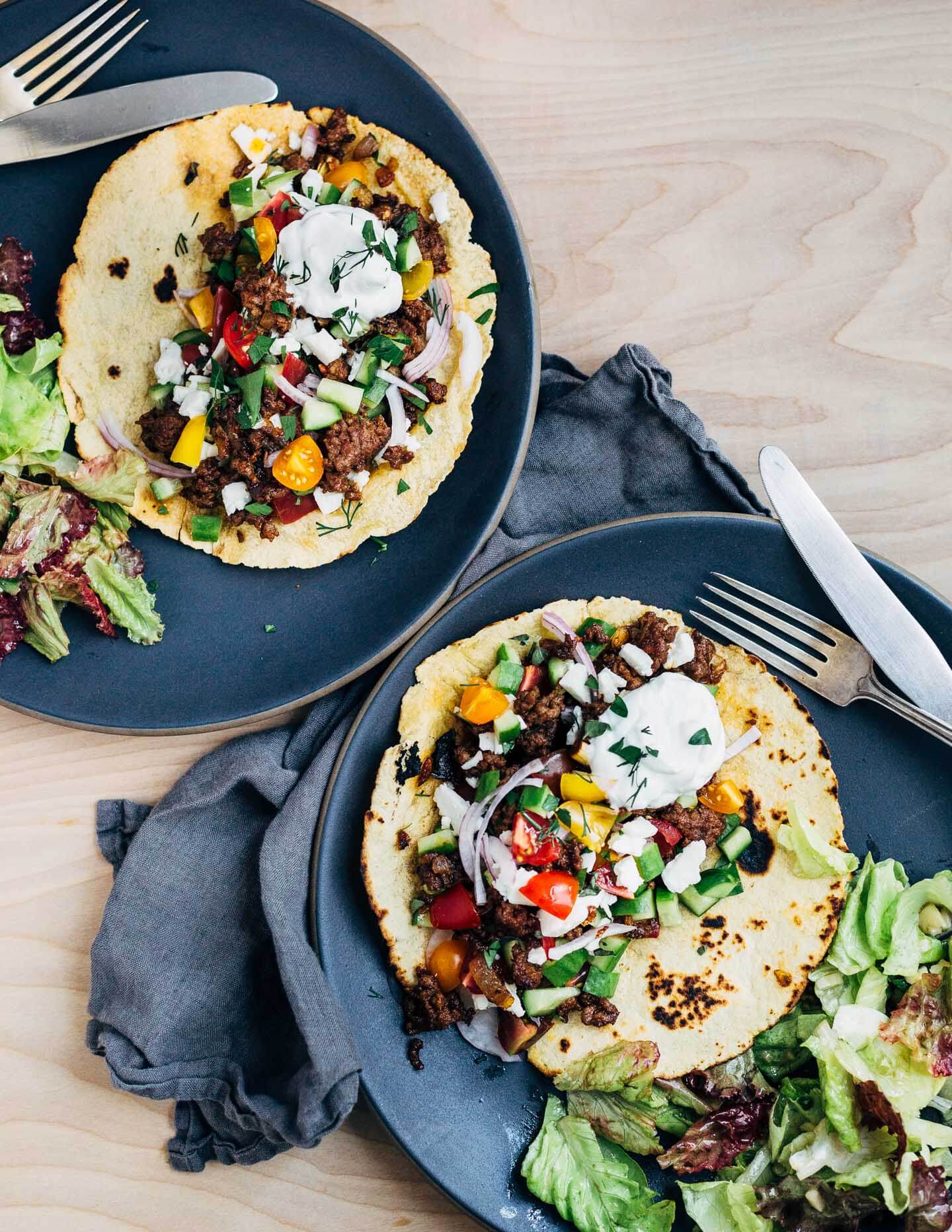 Greek-inspired lamb tacos are a revelation. They're proof that a great dinner can be as simple as sautéing meat with alliums and spices, and chopping up a few vegetables. Add a side salad and maybe some rice, and you have a simple dinner that's ready in under 30 minutes.