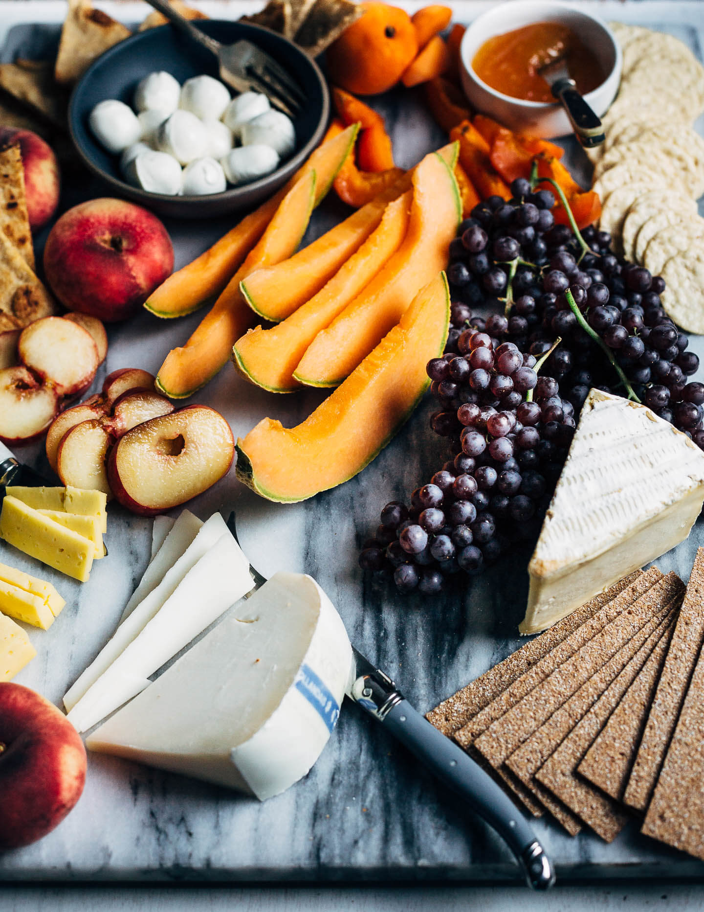 A seasonal summer fruit and cheese board. 